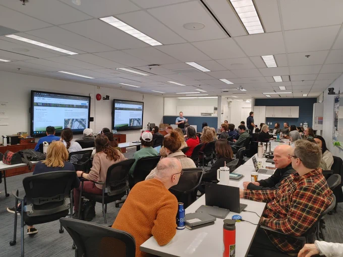 A large meeting room full of people.