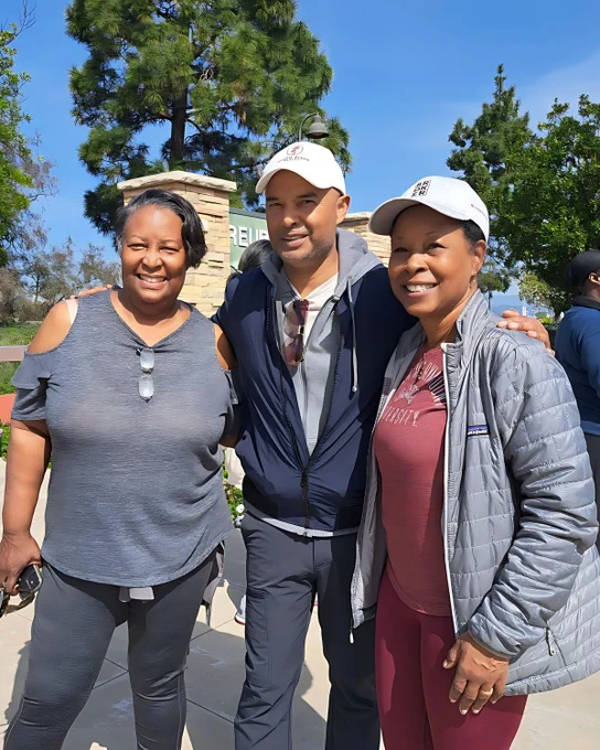 Munif Ali enjoying a sunny day at the park with two women, representing authentic business style, work-life balance culture, and healthy habits.