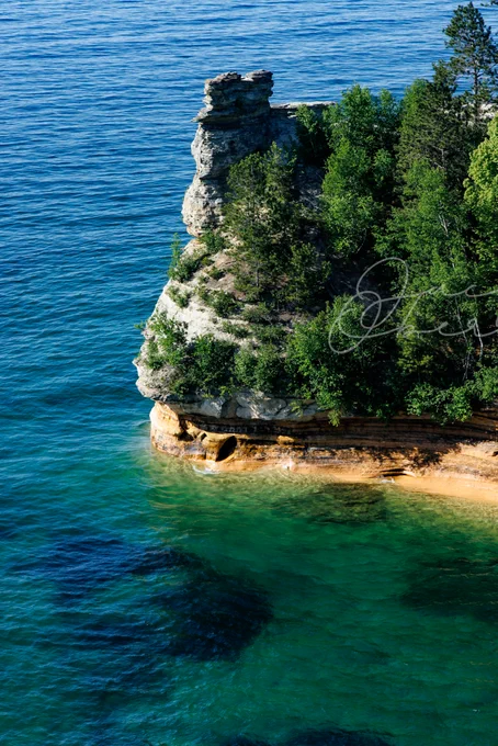 Pictured Rocks Cliff located on Lake Superior Upper Michigan. Photo of a Rocky Cliff jutting into the ocean-like view of lake superior from an overlook.