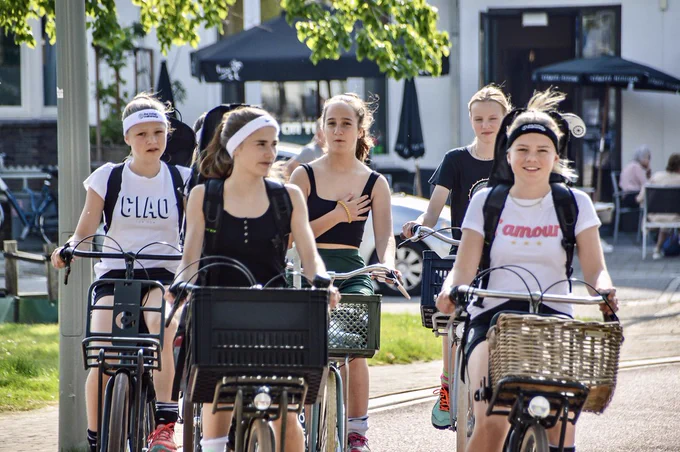People of all ages and abilities use a variety of two- and three-wheeled mobility devices to travel on dedicated cycling infrastructure in Dutch cities.