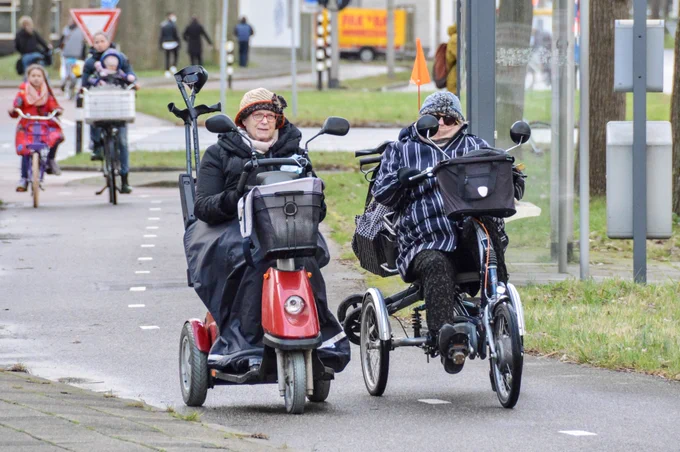 People of all ages and abilities use a variety of two- and three-wheeled mobility devices to travel on dedicated cycling infrastructure in Dutch cities.