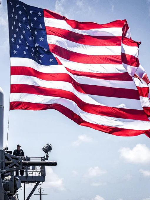 The US flag in the wind aboard the Ticonderoga-class guided-missile cruiser USS Robert Smalls (CG 62). Photo by:  Petty Officer 2nd Class Ange-Olivier Clement Commander, Task Force 70 / Carrier Strike Group 5