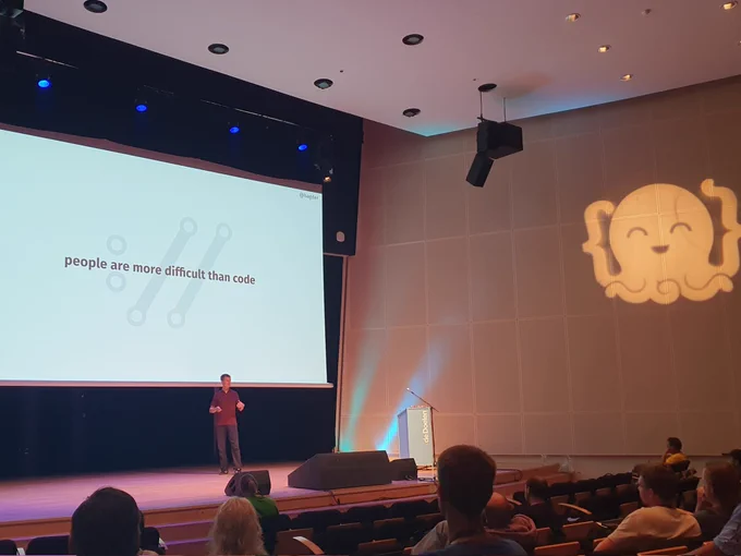 Slide with the text "People are way more difficult than code".