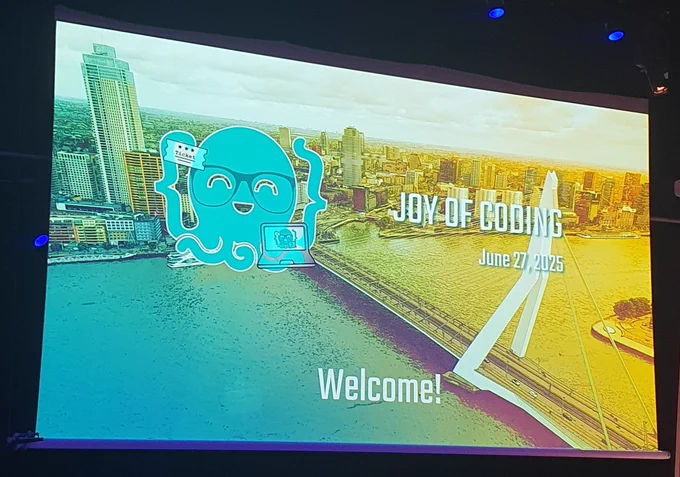 Welcome screen for Joy of Coding showing the octopus mascot, a picture of the Erasmus bridge in Rotterdam and the text Joy of Coding, June 27, 2025 and Welcome!