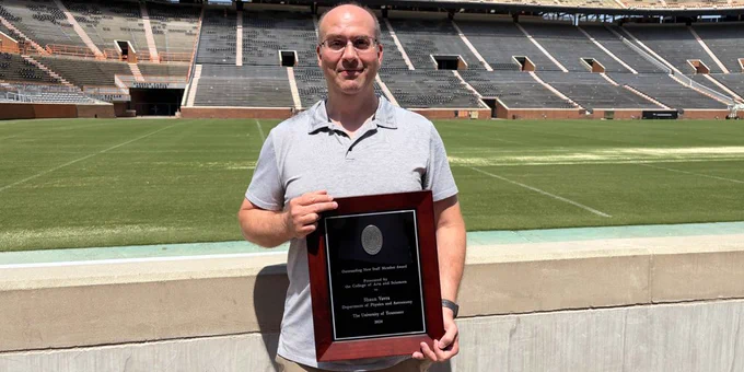 A photo of Shaun Vavra beside the football field in Neyland Stadium.