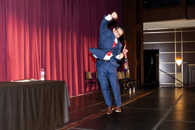 Photo courtesy of MO Boys State. A new citizen jumping for joy after taking the oath.