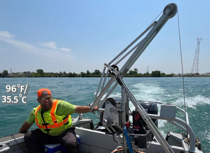 Wear a hat and breathable clothing. (Robert Howell (Lansing), sampling the Detroit River, 2024)