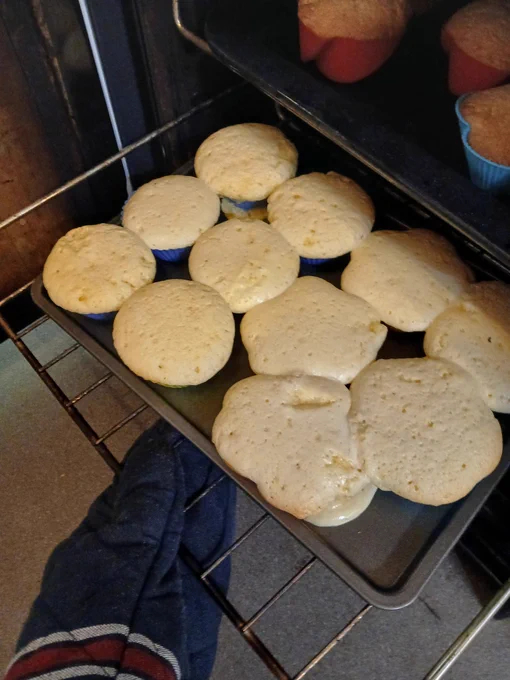 Pale half cooked cakes overflowing from the cake cases 