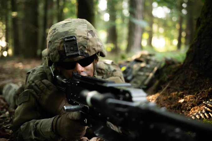 U.S. soldier holds a security position using an M240B machine gun.