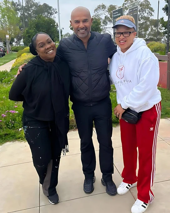 Munif Ali standing with two women outdoors, representing business leaders embracing work-life balance and business strategy in action.
