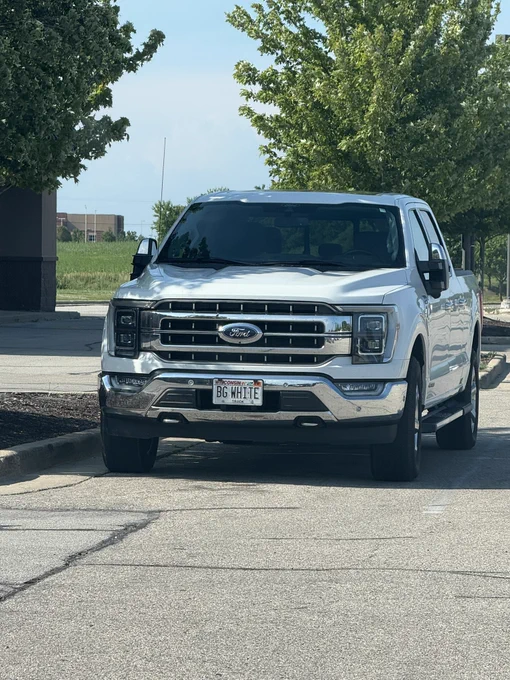 White pickup truck with a license plate that says “BG WHITE”