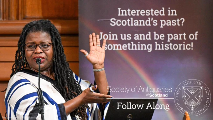 Person giving a lecture with text on the photograph that says: Follow Along