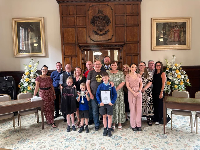 Mayor of St Helens Borough, Cllr Seve Gomez-Aspron, pictured with Jim Housley and friends and family in the town hall