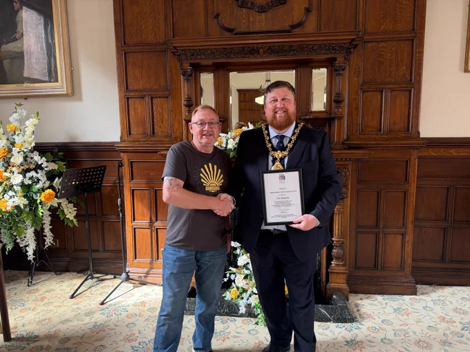 Mayor of St Helens Borough, Cllr Seve Gomez-Aspron, pictured presenting Jim Housley with certificate in the town hall 