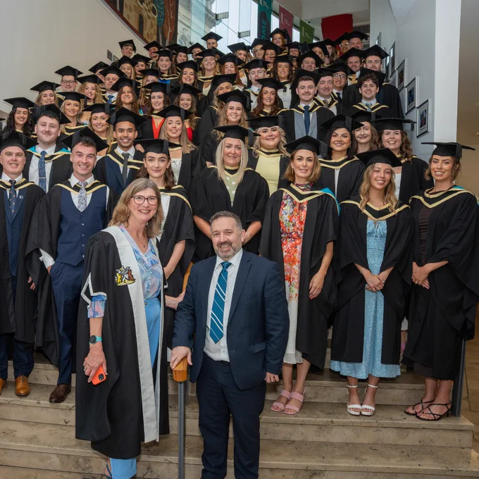 The first cohort of Ulster University School of Medicine Graduates pictured with the School's Foudation Dean Professor Louise Dubras and Minister Robin Swann.
