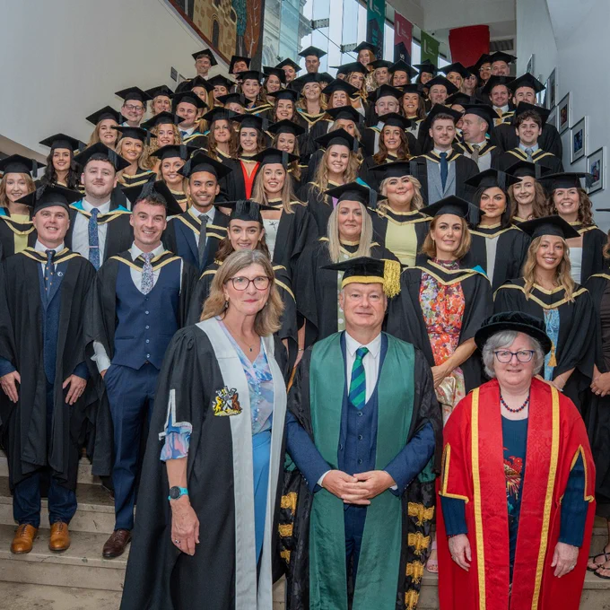 The first cohort of Ulster University School of Medicine Graduates pictured with the School's Foudation Dean Professor Louise Dubras, Vice Chancellor Professor Paul Bartholomew, and Executive Dean of the Faculty of Life and Health Sciences, Professor Carol Curran.