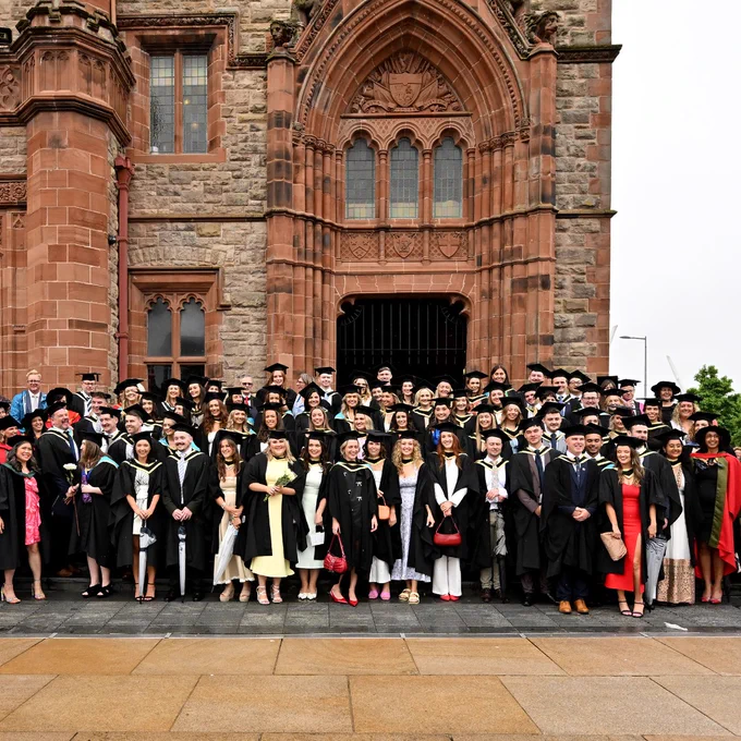 First cohort of graduating doctors from Ulster University outside the Guildhall in Derry~Londonderry.