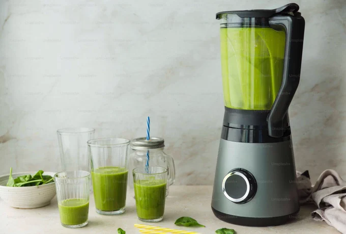 Blender and glasses filled with puree.