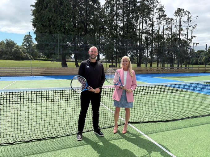 Council Leader Councillor Kelly Parry is pictured with Grant Shearer, Participation Development Manager, Tennis Scotland at the Abbeylands Welfare Park Tennis Courts in Newtongrange.