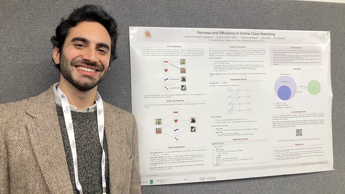 Max Springer standing next to a poster at the NeurIPS Conference in December 2024. 