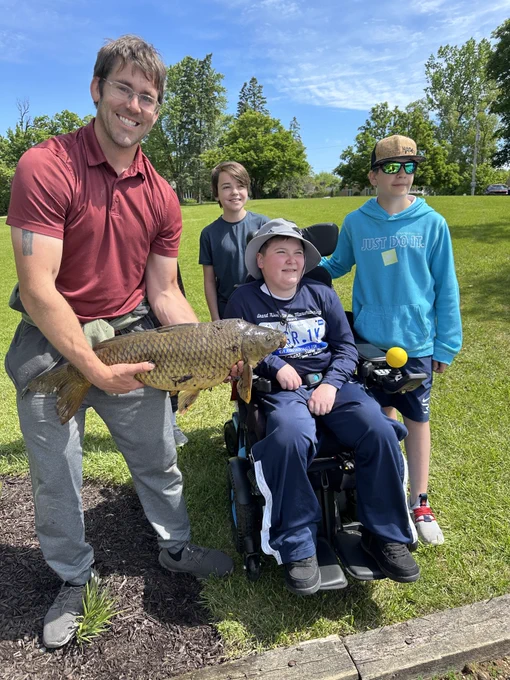 students and staff fishing and showing photos of their fish
