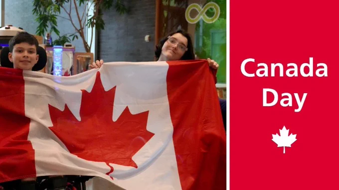 Two individuals celebrating Canada Day, holding a large Canadian flag, with a maple leaf logo and the text "Canada Day" on a red background to the right.