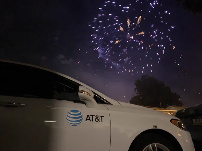 AT&T vehicle in the foreground as fireworks go off behind it