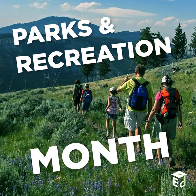 Group of hikers walking on a grassy trail surrounded by wildflowers and trees with mountains in the background under a partly cloudy sky; text in the foreground reads "Parks & Recreation Month"