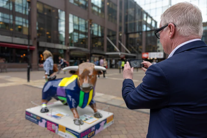 Richard Parker taking a photo of the WMCA bull 'Parker Goals'.