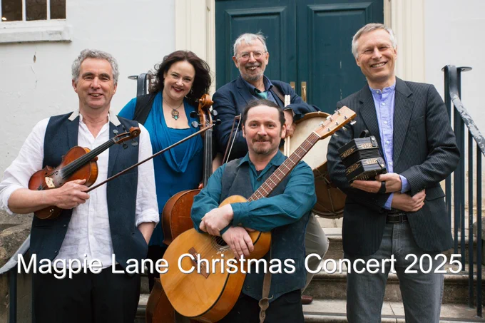 The members of Magpie Lane holding instruments, standing outside the Holywell Music Room in Oxford.