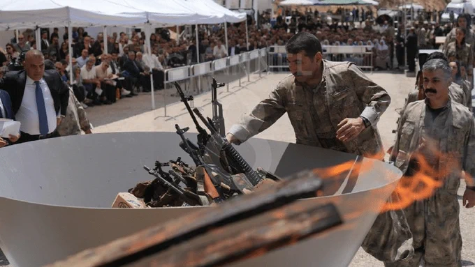 Kurdish PKK militants hand over weapons in Iraq in a special ceremony. Photo: Channel 8.