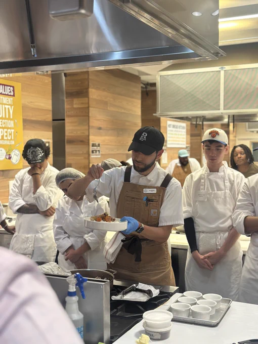 Participants in the First Course N Y C program learning how to work in a restaurant kitchen