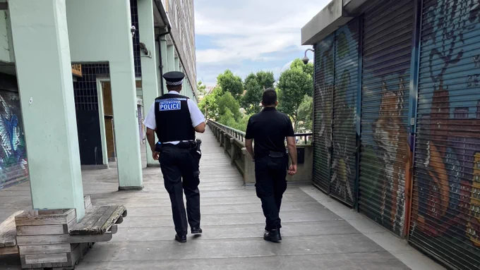 A police officer and community warden on patrol
