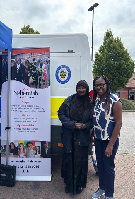 A female Nehemiah staff member advising a female local resident at a public event in Birmingham during Antisocial Behaviour Awareness Week. 