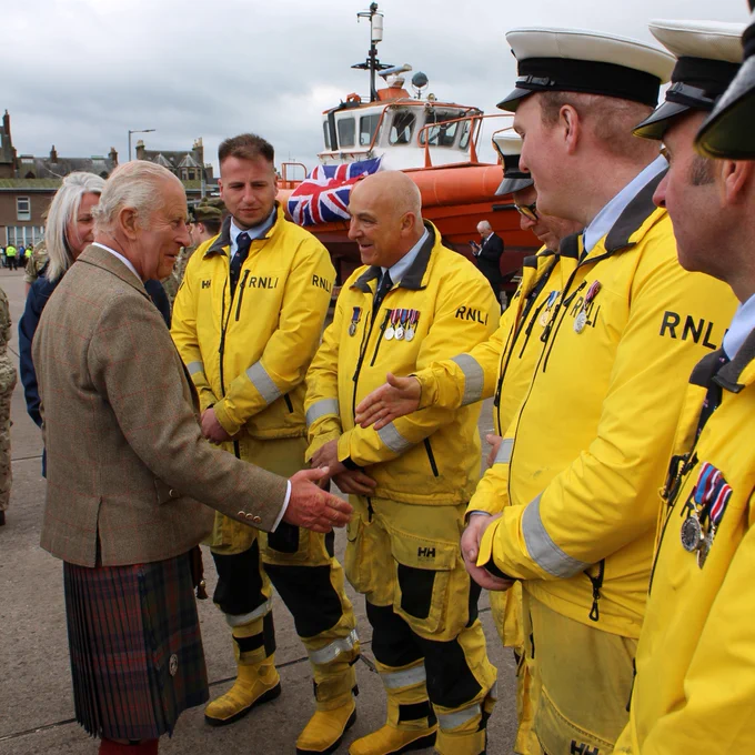 His Majesty King Charles III meeting and shaking hands with crew members from Campbeltown RNLI at Campbeltown harbour.