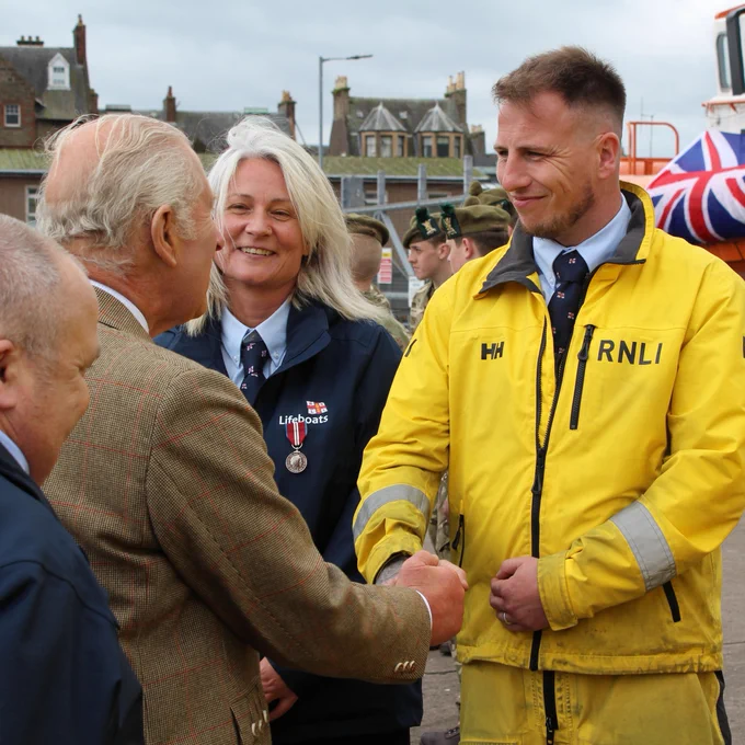 His Majesty King Charles III meeting and shaking hands with crew members from Campbeltown RNLI at Campbeltown harbour.