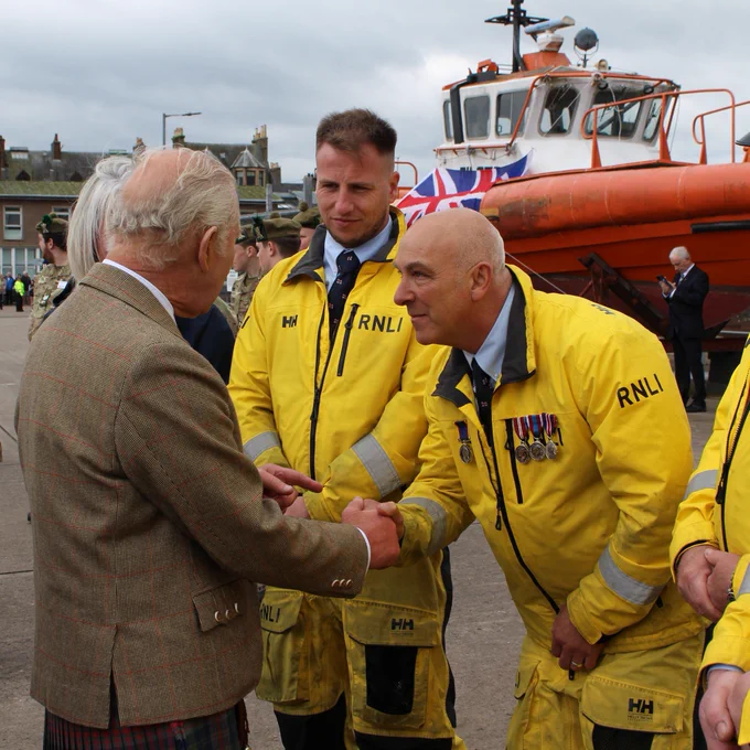 His Majesty King Charles III meeting and shaking hands with crew members from Campbeltown RNLI at Campbeltown harbour.