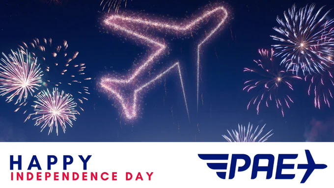 Fireworks and drones in the shape of an airplane light up a dark sky. The words Happy Independence Day and the official Paine Field logo are set at the bottom on a white background.