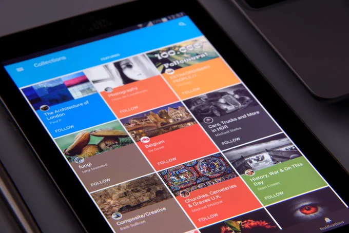 Close-up of a tablet displaying diverse content collections in a grid format.