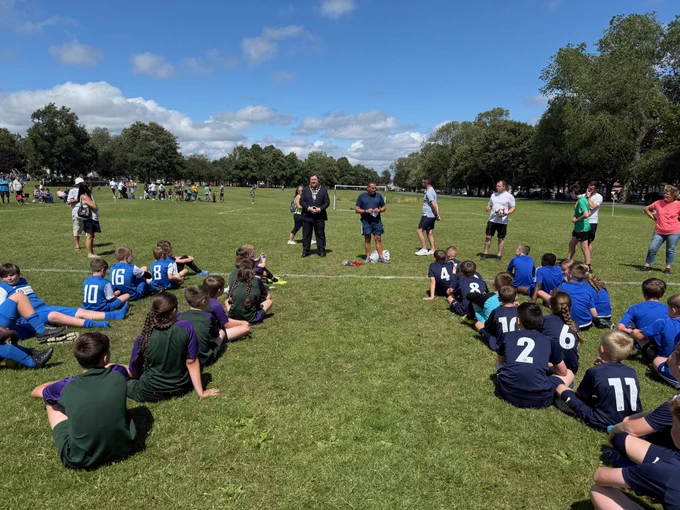 Mayor of St Helens borough, Cllr Seve Gomez-Aspron pictured giving speech to groups of children taking part in football presentation in Sutton Park