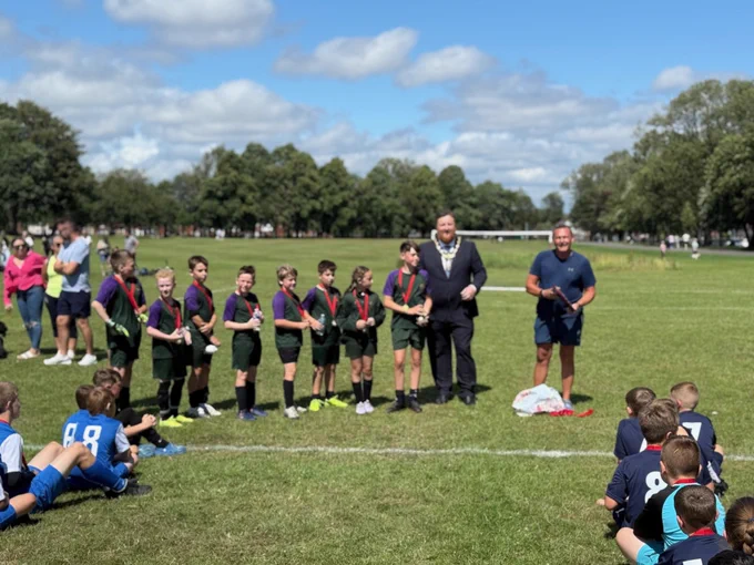 Mayor of St Helens borough, Cllr Seve Gomez-Aspron, pictured with a group of children wearing medals at football presentation in Sutton Park