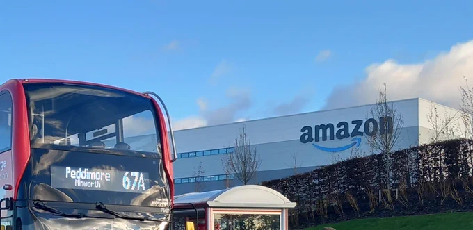West Midlands bus and bus stop with an Amazon building in the background
