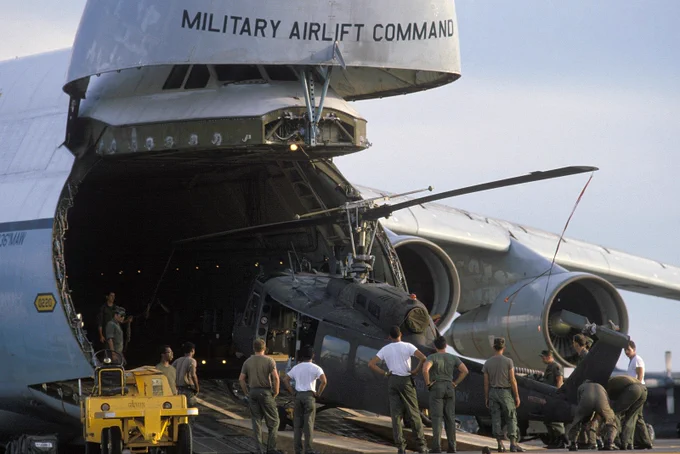Air Force personnel load an Army UH-1H Iroquois helicopter into a 436th Military Airlift Wing C-5A Galaxy aircraft for transport to Ecuador (credit: Digital Public Library of America via Wikimedia Commons)