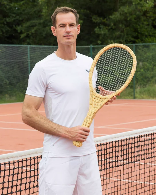 Andy Murray, tennis player, holding a tennis racket made from shortbread.