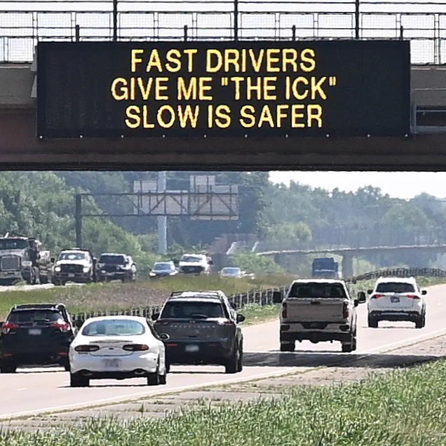 Electronic sign on highway above traffic. The sign reads, "Fast drivers give me ‘the ick.’ Slow is safer.”