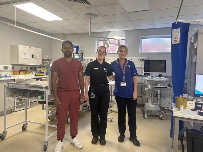 Student Paramedic with Nurse and Doctor standing in treatment room.