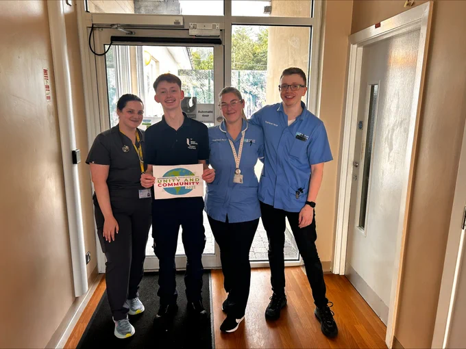 Student Paramedic standing with two nurses and a doctor in hospital corridor.