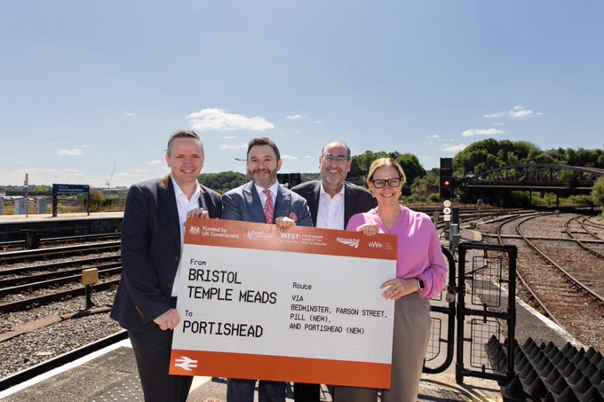 Helen, Cllrs Tony and Mike and Sadik holding up a large train ticket saying Bristol Temple Meads to Portishead