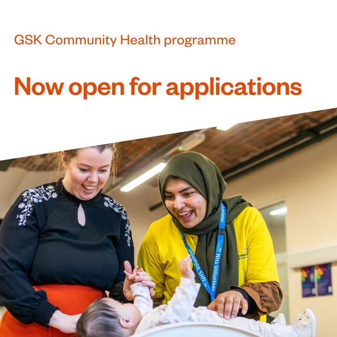 Image promoting GSK Community Health programme, featuring two adults smiling as they interact with a baby on a changing table. Text reads: 'Now open for applications.'