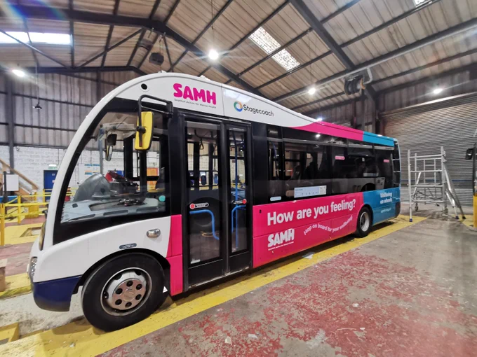 A Stagecoach bus has been outfitted with SAMH decals, including text saying "How are you feeling?"